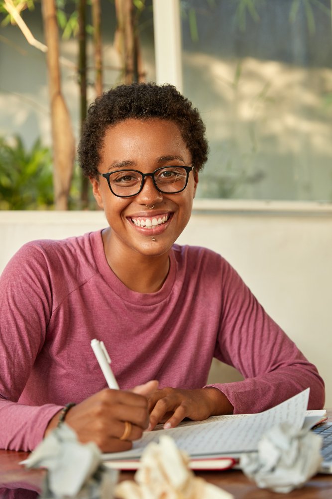 black student wearing glasses smiling