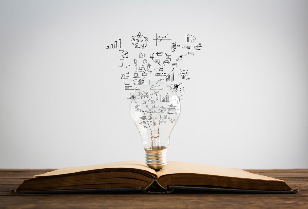 An open book with numbers and formulas emerging from it, signifying knowledge expansion.